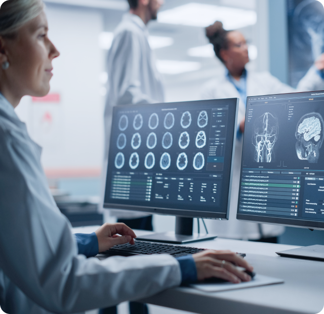 Radiologist reviewing brain scans on RIS-PACS workstation